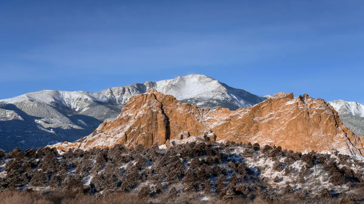 Snow-covered mountain range under a blue sky